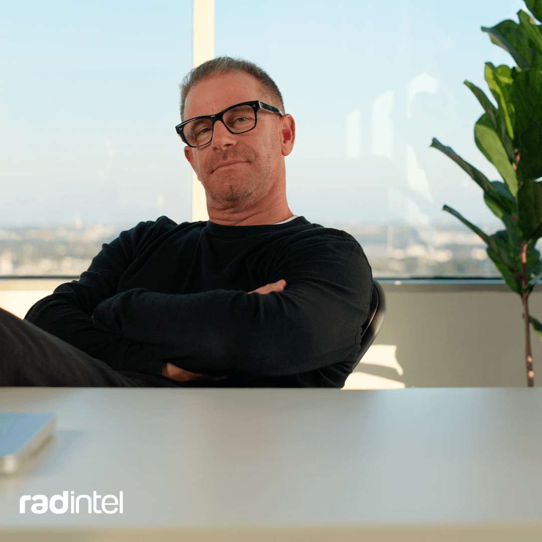 Jeremy Barnett sitting at a desk having just written his Forbes Tech Council piece.