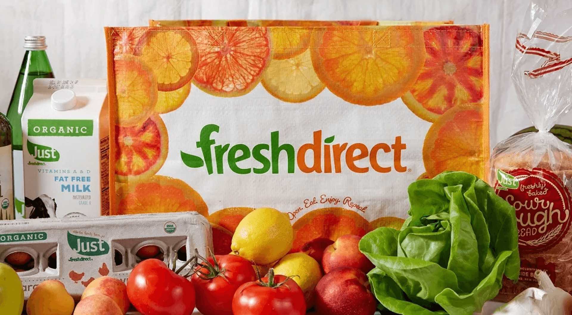 FreshDirect logo surrounded by fruits, vegetables, and other groceries