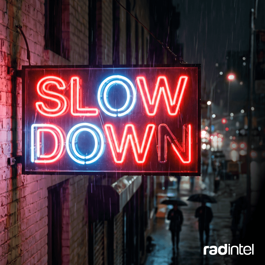Neon sign glowing with the words "slow down."