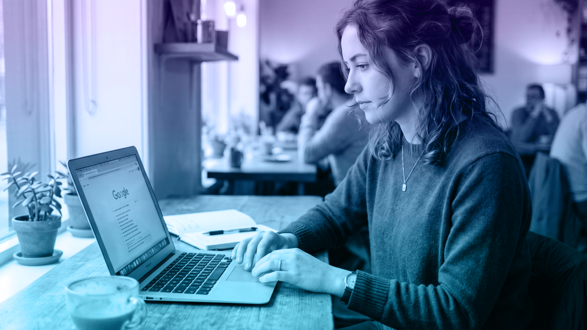 Woman looking up question on Google in cafe.