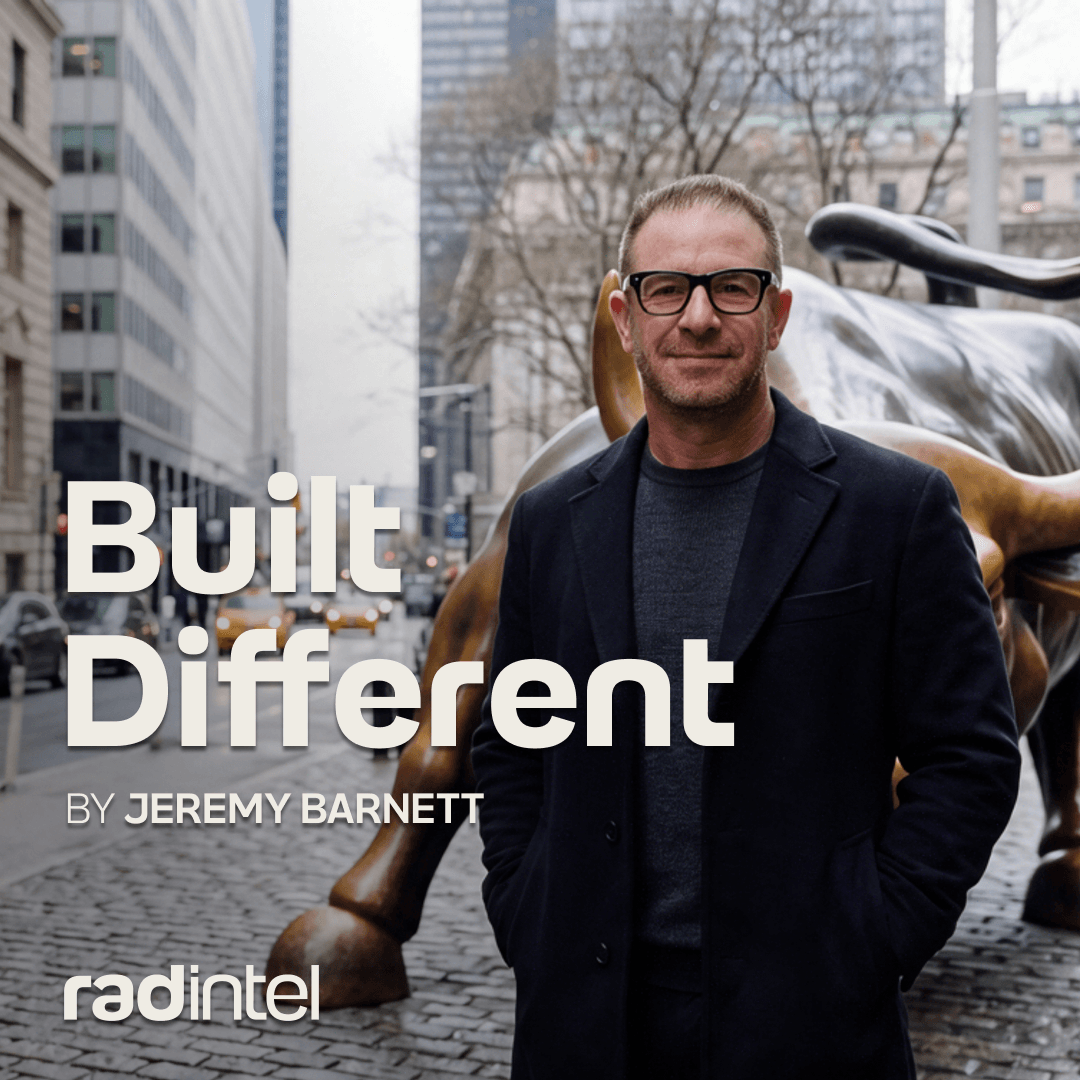 Jeremy Barnett, CEO of RAD Intel, standing in front of the bull statue.