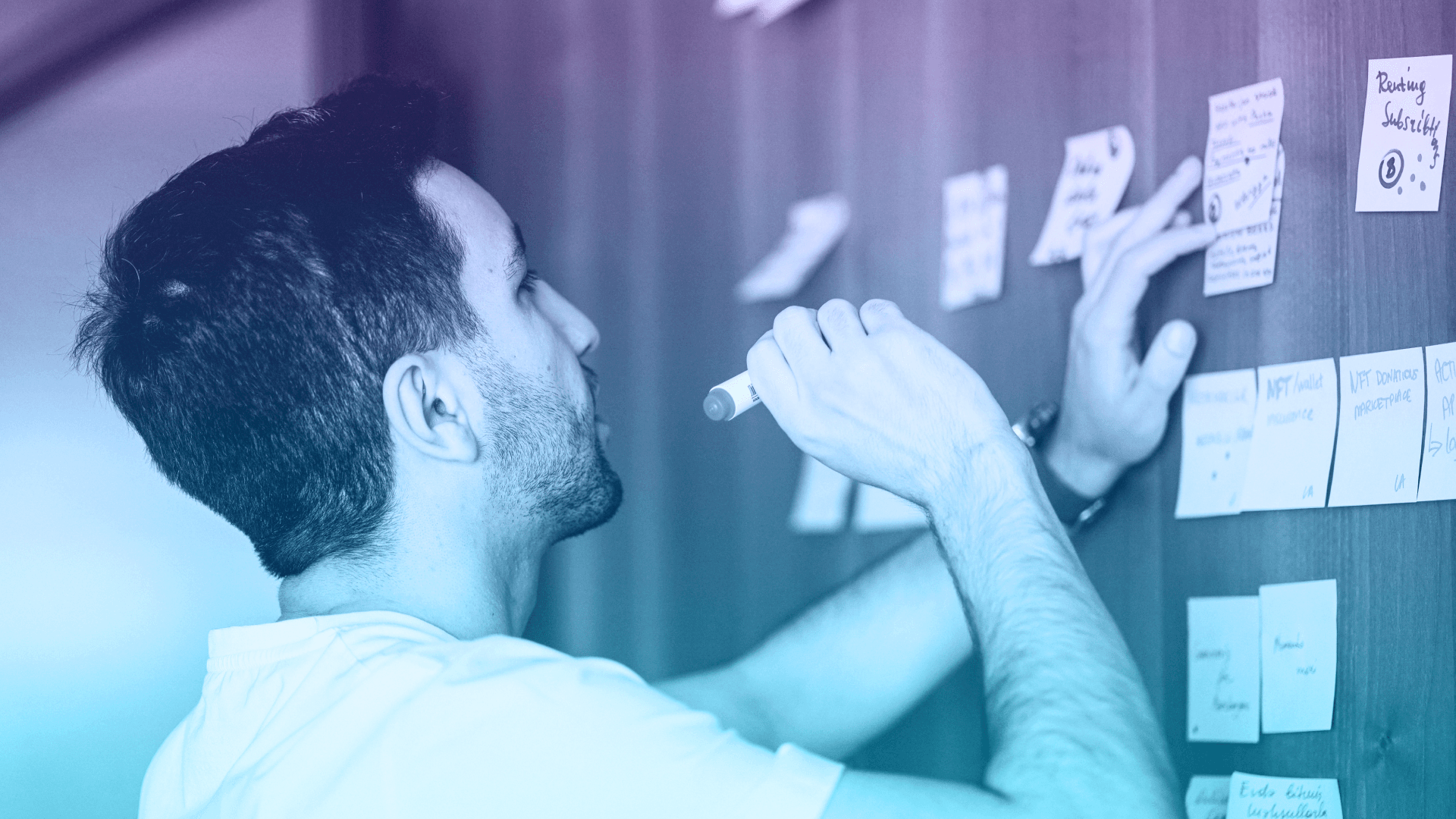 Man writing ideas on sticky notes for RAD Intel.
